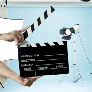 Movie Clapboard in studio with film lights and a blue background